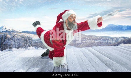 Le Père Noël en costume traditionnel blanc rouge en face de blanche neige paysage d'hiver panorama. X-mas, Noël, cadeaux concept. Banque D'Images