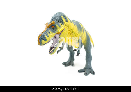 Vue avant du jaune bleu Battat Tyrannosaurus rex dinosaur toy, isolé sur un fond blanc. Banque D'Images