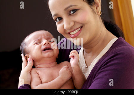 Cheerful mère avec bébé nouveau-né Banque D'Images