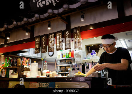 Serveur dans le restaurant à l'intérieur du marché Nishiki, Kyoto, Japon Banque D'Images