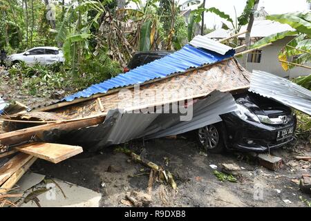 Banten, Indonésie. Dec 23, 2018. Une voiture est enterré à débris après un tsunami a frappé dans le détroit de Sunda Pandeglang, province de Banten, en Indonésie, le 23 décembre 2018. Le total des victimes d'un tsunami provoqué par l'éruption du volcan Krakatau Enfant a augmenté à 168 personnes dans les régions côtières du détroit de la sonde de l'ouest de l'Indonésie, la fonctionnaire de l'agence dit ici le dimanche. La catastrophe a tué au moins 168 personnes, en ont blessé au moins 745, et s'est effondré un total de 430 maisons et neuf hôtels, et a causé des dommages à des dizaines de navires. (Xinhua/Wahyu Wening) Credit : Xinhua/Alamy Live News Banque D'Images