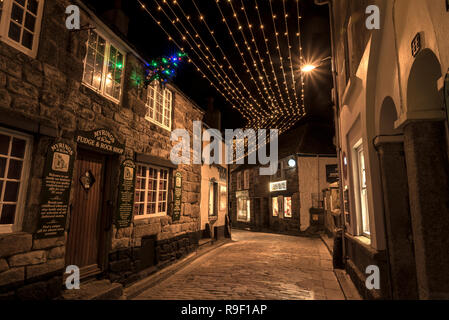 Les lumières de Noël au-dessus des rues pavées de St Ives en Cornouailles avec ses jolies rues étroites et le port . Banque D'Images