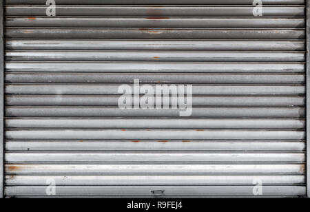 Porte de garage fermé, porte rouleau de métal rouillé, texture de fond photo, vue de face Banque D'Images