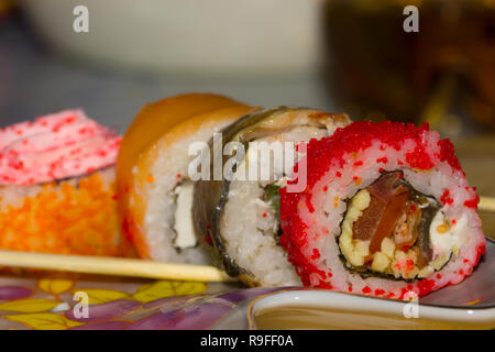 Rouleaux de sushi avec du saumon, l'anguille, le fromage à la crème Philadelphia, caviar tobica et bâtonnets sur la plaque Banque D'Images