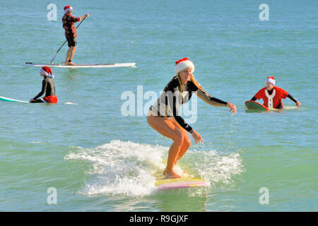 Cocoa Beach, Floride, USA. 24 décembre 2018 au cours des neuf dernières années, avant que le père Noël offre des jouets et des cadeaux, il a été de se détacher d'attraper quelques vagues dans Cocoa Beach la veille de Noël matin. L'événement de Santa Surf est une tradition annuelle de Cocoa Beach qui rassemble des centaines de surfeurs habillés en Père Noël à l'une des plus célèbres plages du monde. Crédit photo : Julian Poireau/Alamy Live News Banque D'Images