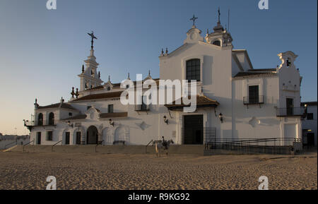 Un homme sur un cheval, c'est prier en face de l'Ermita de El Rocio église à la fin de la journée, El Rocio, Espagne Banque D'Images