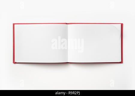 Concept design - Vue de dessus couverture cartonnée rouge portable avec open & curl flip page laminées isolé sur fond de immersive Banque D'Images
