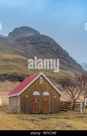 Pour l'armoire outhouse Église historique Kalfafellsstadur en Islande avec une montagne en arrière-plan Banque D'Images