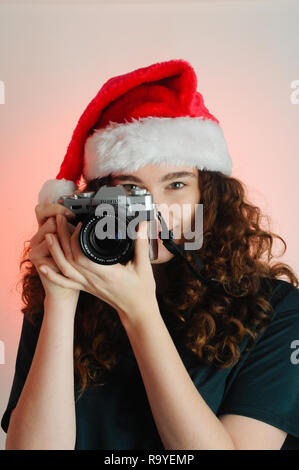 Happy girl habillé pour célébrer Noël taking photo Banque D'Images