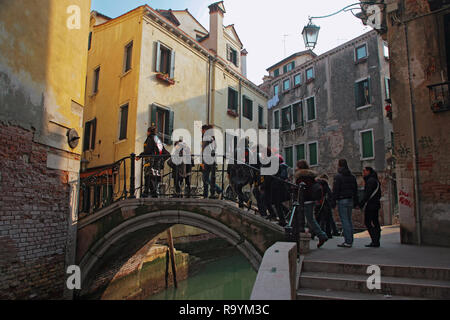 Ponte del Megio, Santa Croce, Venise, Italie : un groupe de touristes traversent le pont sur le Rio del Megio Banque D'Images