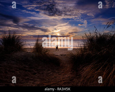 Coucher du soleil au-delà des dunes de sable sur West Wittering beach près de Chichester, West Sussex. Banque D'Images