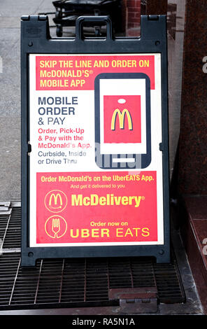 Un signe extérieur d'un McDonald's à Greenwich Village, la promotion d'une nouvelle application mobile et la possibilité de commander sur McDelivery Uber et mange. Banque D'Images