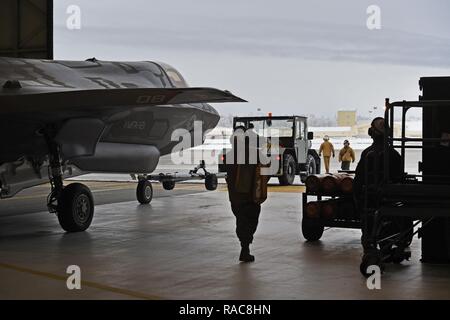 Marines affectés à l'Escadron de chasse marine attaque (VMFA) 121, 3rd Marine Aircraft Wing, déplacer F-35b dans un hangar, le 13 janvier 2017, lors d'un arrêt sur une base commune Elmendorf-Richardson, Alaska, en route vers Iwakuni Marine Corps Air Station, au Japon. VMFA-121 est le premier escadron opérationnel F-35B dans le Corps des Marines, avec son déménagement à 1ère aile d'avion à Iwakuni Marine. Le F-35B a été développé pour remplacer le Corps des Marines F/A-18 Hornet AV-8B Harrier, et EA- 6B Prowler. La version à décollage court atterrissage vertical (STOVL) est un véritable multiplicateur de force. La combinaison unique de furtivité et d'avant-garde Banque D'Images