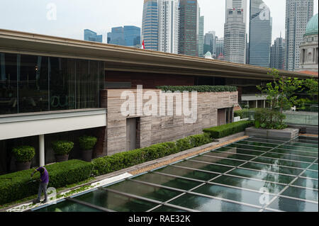 20.12.2018, Singapour, République de Singapour, en Asie - Un travailleur est le fraisage des couvertures sur le toit-terrasse de la Galerie nationale de Singapour. Banque D'Images