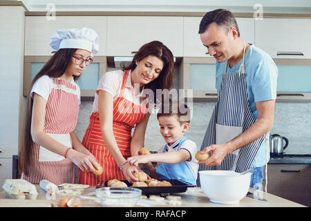 Une famille heureuse prépare la cuisson dans la cuisine Banque D'Images