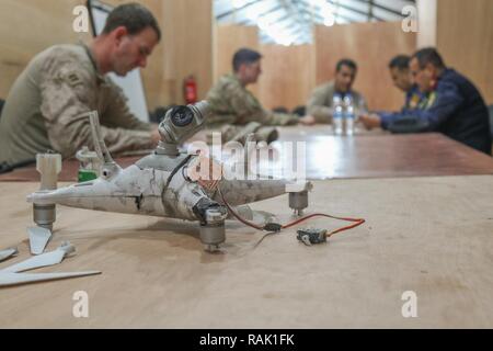 Un véhicule aérien sans pilote ISIS capturés par la police fédérale irakienne repose sur une table dans un échange de renseignement à l'engagement du chef du Centre d'opérations conjoint, à Qayyarah aérodrome Ouest, l'Iraq, le 9 février 2017. Déployées à l'appui de l'intervention conjointe combinée Force-Operation résoudre inhérents, les forces de la coalition permettent à leurs partenaires des forces de sécurité iraquiennes dans le but d'aider et de conseiller, planification de la mission de contribuer, collecte et analyse des renseignements, la protection de la force et la précision de forêt pour atteindre la défaite militaire d'ISIL. Les GFIM-OIR est la Coalition mondiale pour vaincre ISIS en Iraq et en Syrie. Banque D'Images