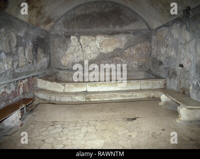 L'Italie. D'Herculanum. Bains d'urbains. Le Centre Thermae. Ils ont été construits autour du début du 1er siècle après JC, et divisé en sections pour les hommes et les femmes. L'intérieur de la 'femme', le caldarium bain d'eau chaude. Piscine en marbre et un coin salon. La Campanie. Banque D'Images