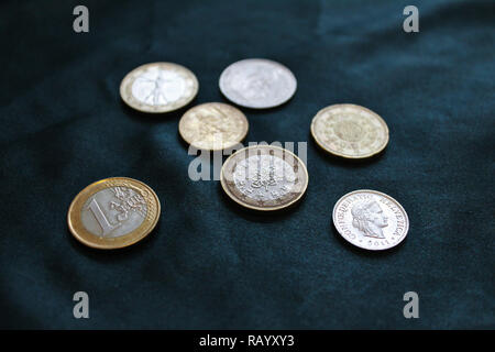 Photo Gros plan d'en haut, les pièces de monnaie, Euro et Franc Suisse, portant sur cher à fond vert et soyeux Banque D'Images