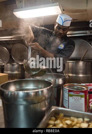 Océan Pacifique (déc. 10, 2016) Maître de 3e classe Laquintis James, de Chicago, prépare la soupe aux légumes à l' USS JOHN C. STENNIS (CVN 74) cuisine. John C. Stennis est en cours d'effectuer un exercice de routine dans la 3ème zone de responsabilité de la flotte. Banque D'Images