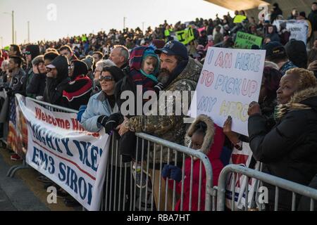 La NORFOLK (30 décembre 2016) Les amis et les membres de la famille de marins à bord du porte-avions USS Dwight D. Eisenhower (CVN 69) attendre sur le quai que le navire arrive à son port d'attache à Norfolk Naval Station. Le Groupe aéronaval d'Eisenhower a mené un combat de sept mois de déploiement les États-Unis 5e et 6e secteurs d'opération de la flotte à l'appui de l'opération inhérents à résoudre, les opérations de sécurité maritime et les efforts de coopération en matière de sécurité dans le théâtre. Banque D'Images