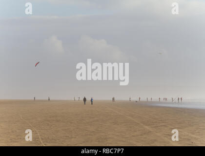 Parafoil et les promeneurs sur la plage de Pembrey. Banque D'Images