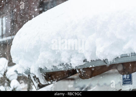 Transport de la neige sur le toit, d'après deux jours de neige. D'épaisses couches accroché sur le toit de maison. Allemagne Bavière Banque D'Images