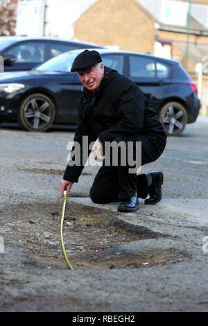 La mesure de l'homme grand pot-trous dans un parking public à Bognor Regis, West Sussex, UK. Banque D'Images