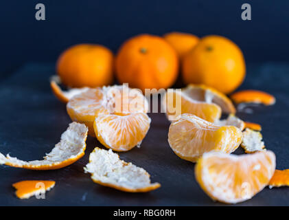 Mandarines et des sculptures sur un fond sombre Banque D'Images