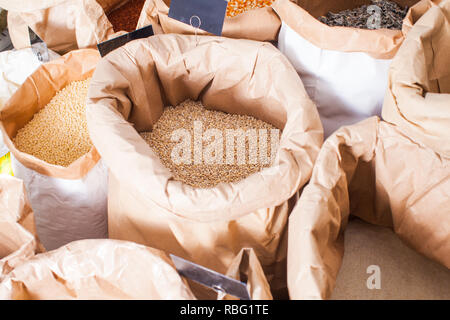 Diversité des grains entiers et en bonne santé les produits alimentaires vendus dans les grands sacs en papier. Concept de soins de santé Banque D'Images