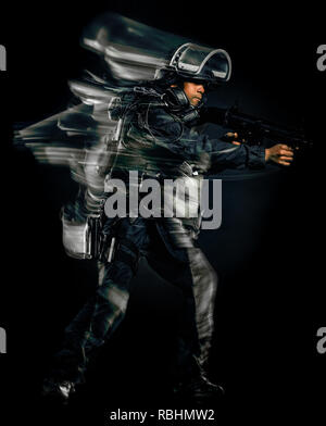 Un soldat des forces tactiques swat police man studio shot isolé sur fond noir Banque D'Images