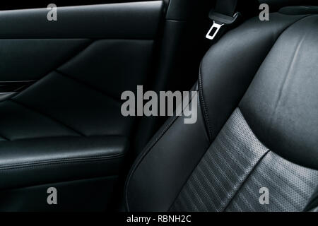 Voiture de luxe moderne intérieur cuir perforé noir. Partie de siège de voiture en cuir détails. Détails de l'intérieur automobile moderne Banque D'Images