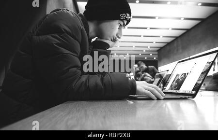 STRASBOURG, FRANCE - 10/01/2018 : Jeune homme travaillant sur ordinateur portable Apple MacBook Pro Banque D'Images