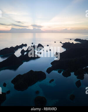 Remote îles calcaires forment un labyrinthe dans une lagune tropicale dans la région de Raja Ampat, en Indonésie. Cette région diversifiée est connu comme le cœur du Triangle de Corail. Banque D'Images