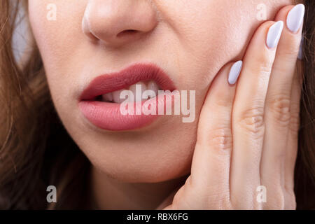 Close-up d'une femme souffrant de douleurs dentaires Banque D'Images