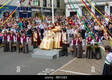 La reine peut et tout son cortège et Maypole danseurs après son couronnement à la célébration annuelle de Mayfair ; Great Torrington, Devon, UK. Banque D'Images