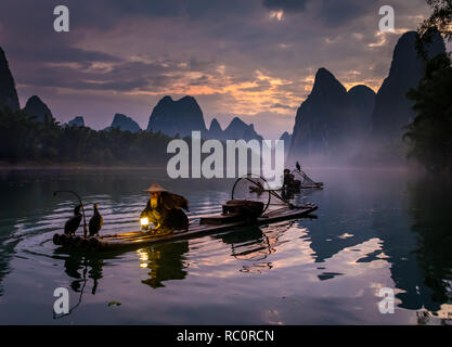 Le Cormorant fisherman et ses oiseaux sur la rivière Li à Yangshuo, Guangxi, Chine Banque D'Images