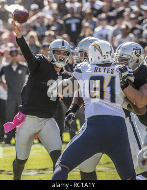 Oakland, Californie, USA. 12 octobre, 2014. Oakland Raiders quarterback Derek Carr (4) passe ball lors d'un rush le dimanche, Octobre 12, 2014, dans la région de Oakland, Californie. Les chargeurs a défait les Raiders 31-28. Crédit : Al Golub/ZUMA/Alamy Fil Live News Banque D'Images