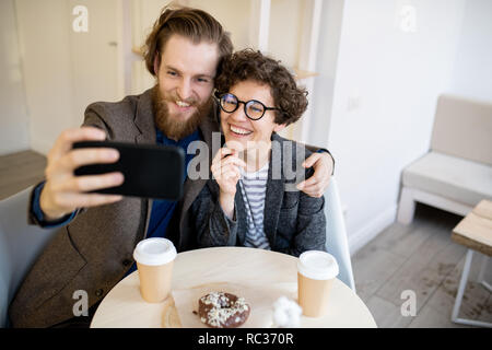 Heureux couple hipster en selfies cafe Banque D'Images