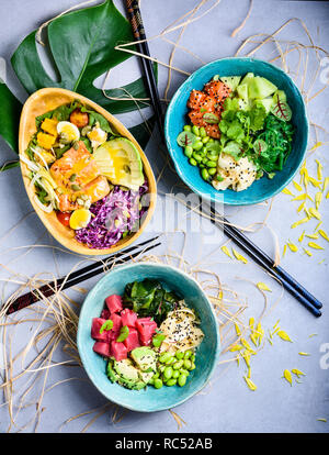 Hawaiian poke poisson bols avec le saumon et le thon et ingrédients sains. Fruits de mer cuisine asiatique. Haut de la vue, télévision lay. Banque D'Images