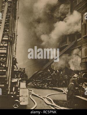 Ubduing «une conflagration dans une étroite rue de ville', c1935. Créateur : Inconnu. Banque D'Images