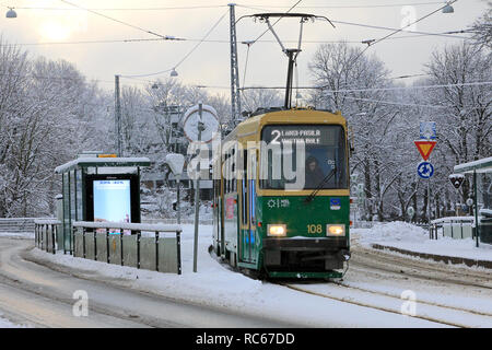 Helsinki, Finlande - 9 janvier 2019 : HSL Vert le tram n° 2 sur un arrêt de tram sur un jour de l'hiver avec des chutes de neige à Helsinki. Banque D'Images