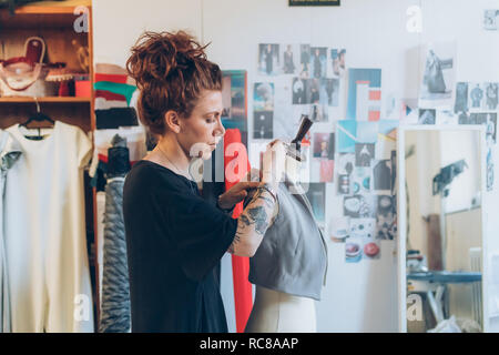 Fashion designer pinning garment sur mannequin de couturière Banque D'Images