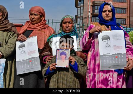 15 janvier 2019 - Srinagar, J&K, l'Inde - proches des personnes disparues et des photographies de calendriers attente Personnes disparues au cours d'un calendrier des sorties à Srinagar, Cachemire sous administration indienne. Depuis janvier 2016, l'Association des Parents des parents de disparus (APDP) publie son calendrier annuel, qu'il appelle ''un document mémoire''. Le calendrier est un montage d'esquisses d'après les photographies de l'homme ''disparu'' de la part de l'état, ainsi que les détails de leur disparition. Credit : Saqib Majeed/SOPA Images/ZUMA/Alamy Fil Live News Banque D'Images