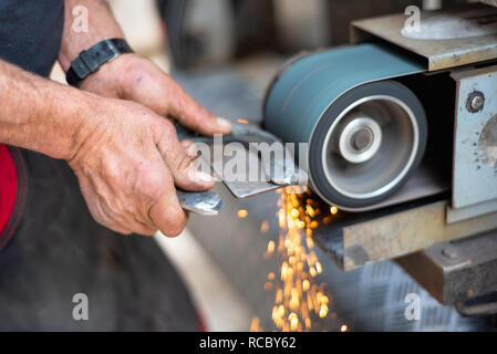 L'industrie du métal. Surface métallique de finition sur machine de meulage . Banque D'Images