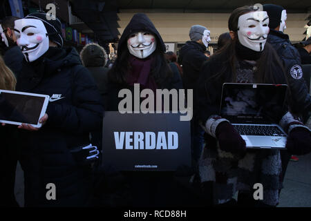 Des militants pour les sans-voix anonyme portant des masques et la tenue d'un ordinateur portable au cours d'une manifestation visant à dénoncer l'exploitation des animaux au public à la Plaza Callao Madrid, Espagne. Pour les sans-voix anonymes est une organisation d'activistes de la rue dédiée à la libération animale totale. Banque D'Images