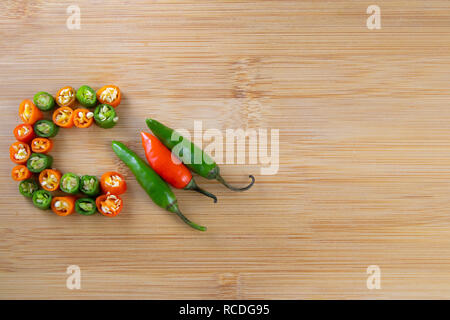 Piment hachés en rouge et vert sur la surface en bois Banque D'Images