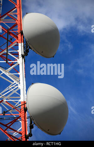 Partie d'une tour avec des antennes sur fond de ciel bleu et nuages Banque D'Images