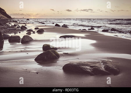 Plage pittoresque avec une des pierres sur le coucher du soleil, selective focus, harmonisation des couleurs appliquées. Banque D'Images