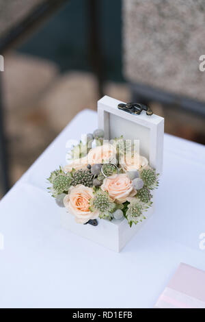 Coffret avec les anneaux de mariage et cérémonie pour fleurs fraîches Banque D'Images