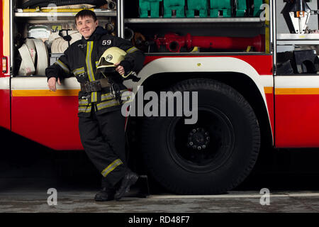 Photo de jeune homme pompier près de fire truck Banque D'Images